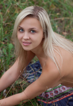 18 year old girl Agnes uncovers her perky tits as she gets completely naked